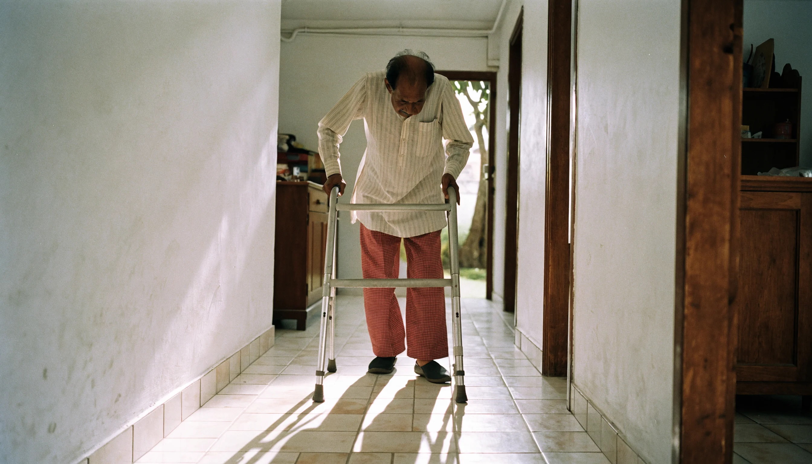 Single older patient walking with a frame during recovery from a broken hip