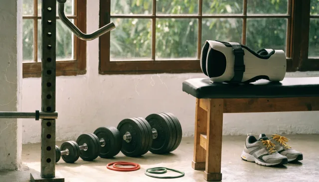 People-free sports-medicine still life with anatomical models, imaging and rehabilitation equipment illustrating Returning to the Gym After ACL Surgery: What’s Safe and When